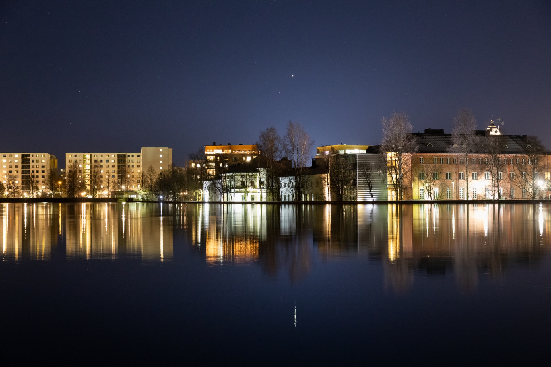 Oulu city reflection in the water at the night time.