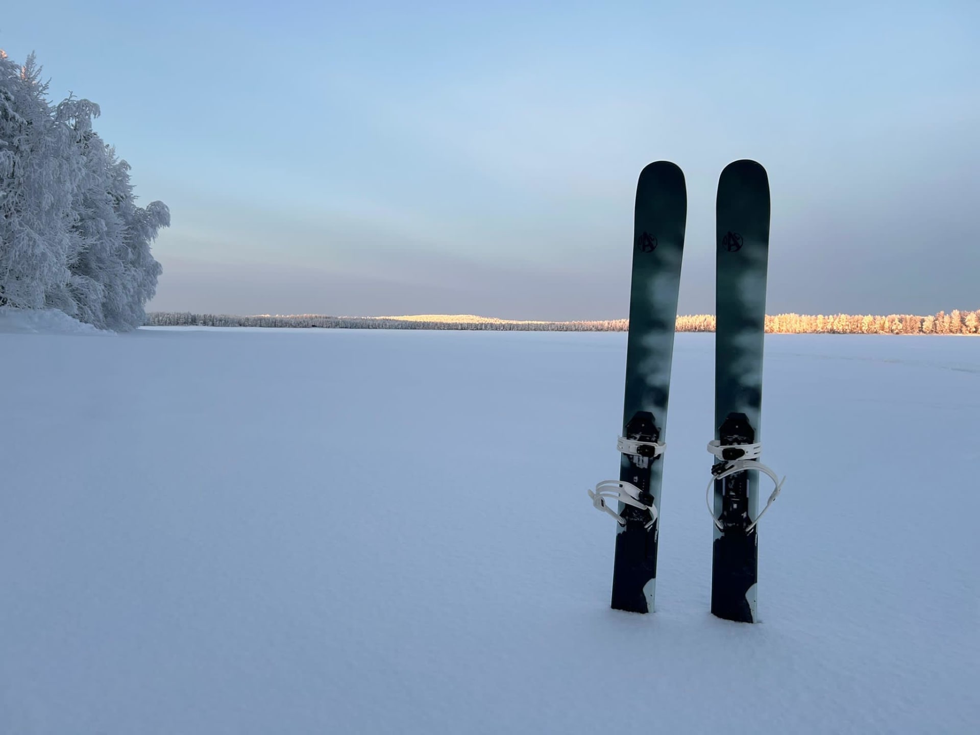 Forest skis on Lake Norvajarvi with a cotton candy sky