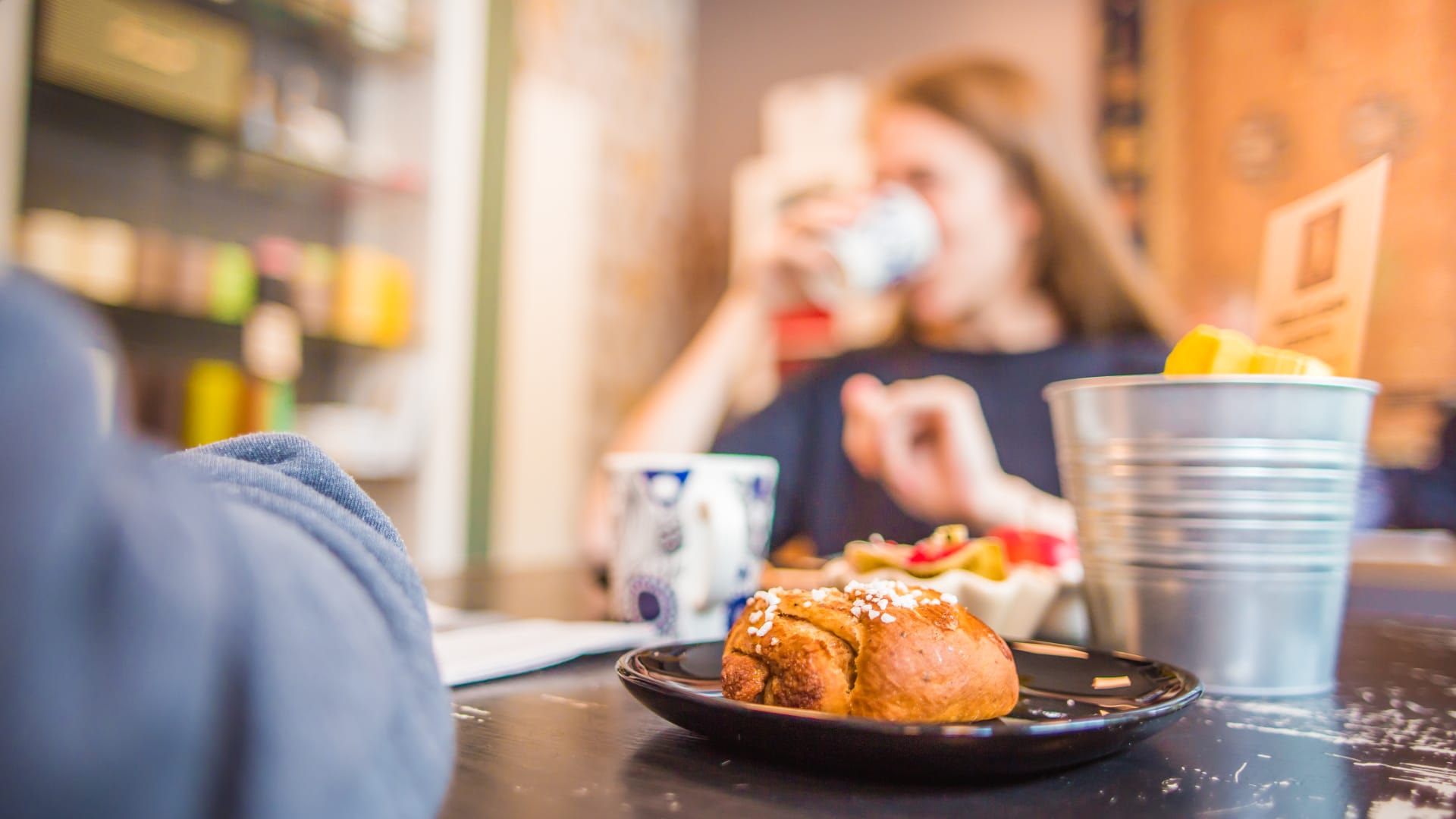 A man and a woman enjoying delicious Finnish cinnamon rolls and artisan coffee at Bakery Cafe Puusti, Tampere, Finland