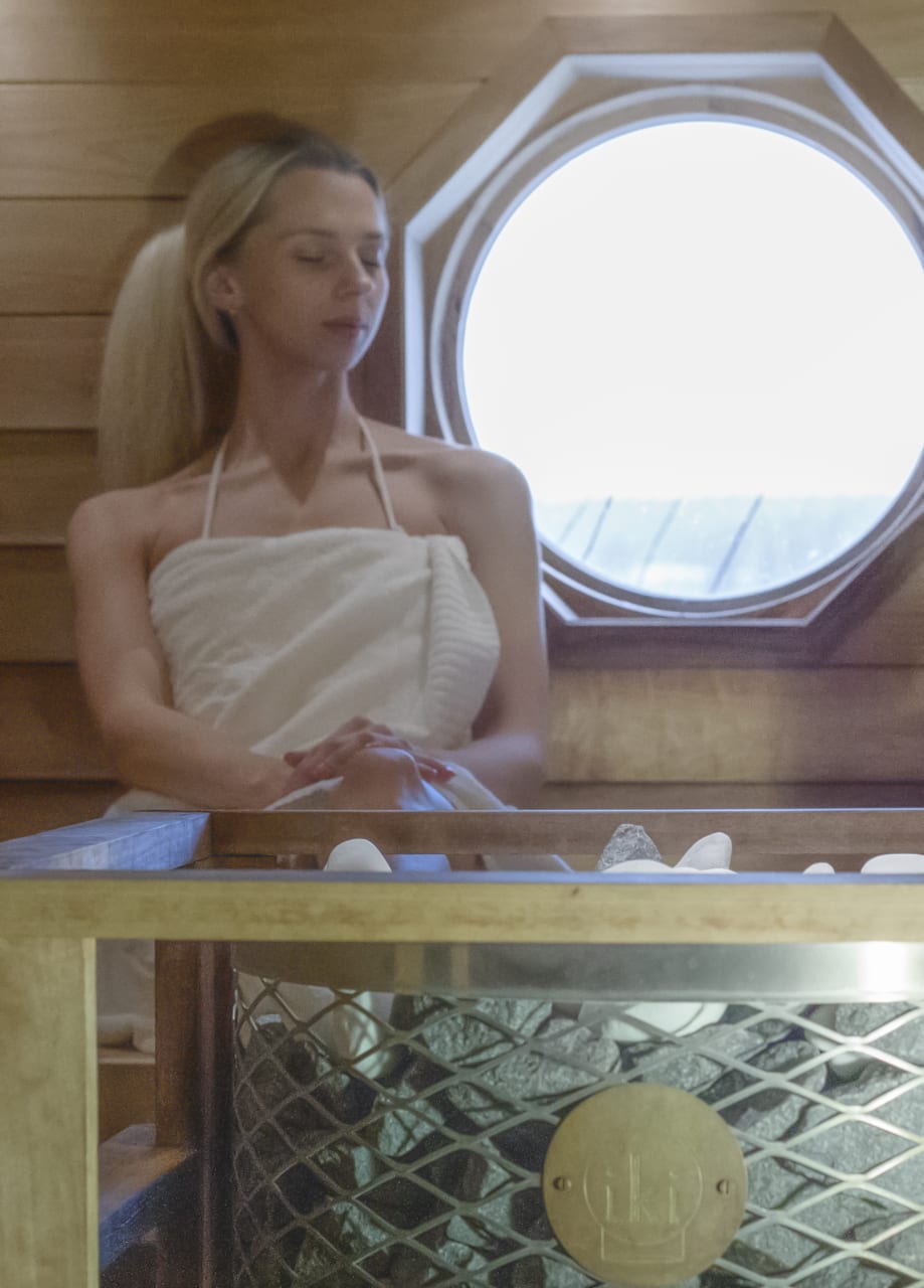 A person relaxing in the sauna.