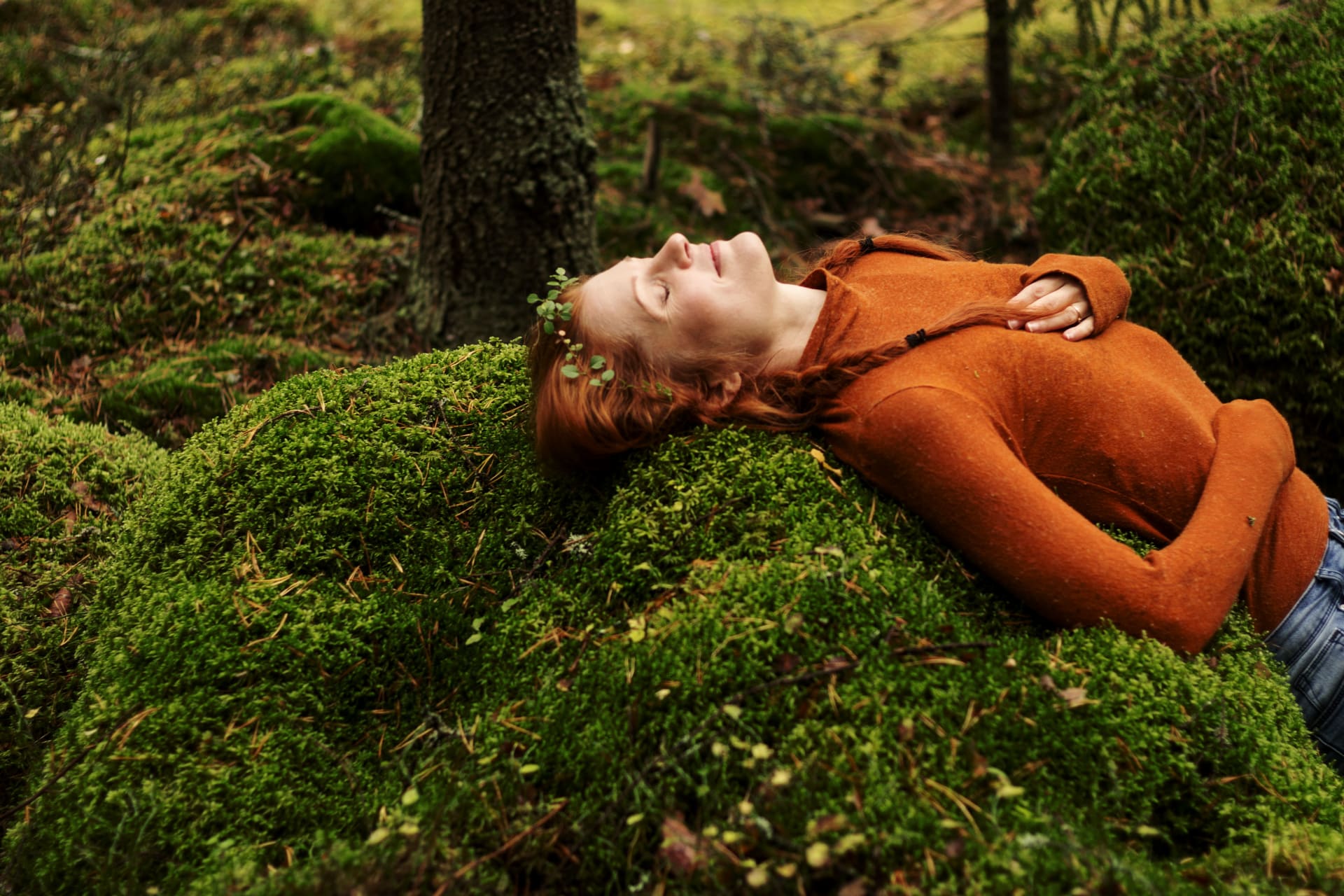 Woman on a bed of moss.