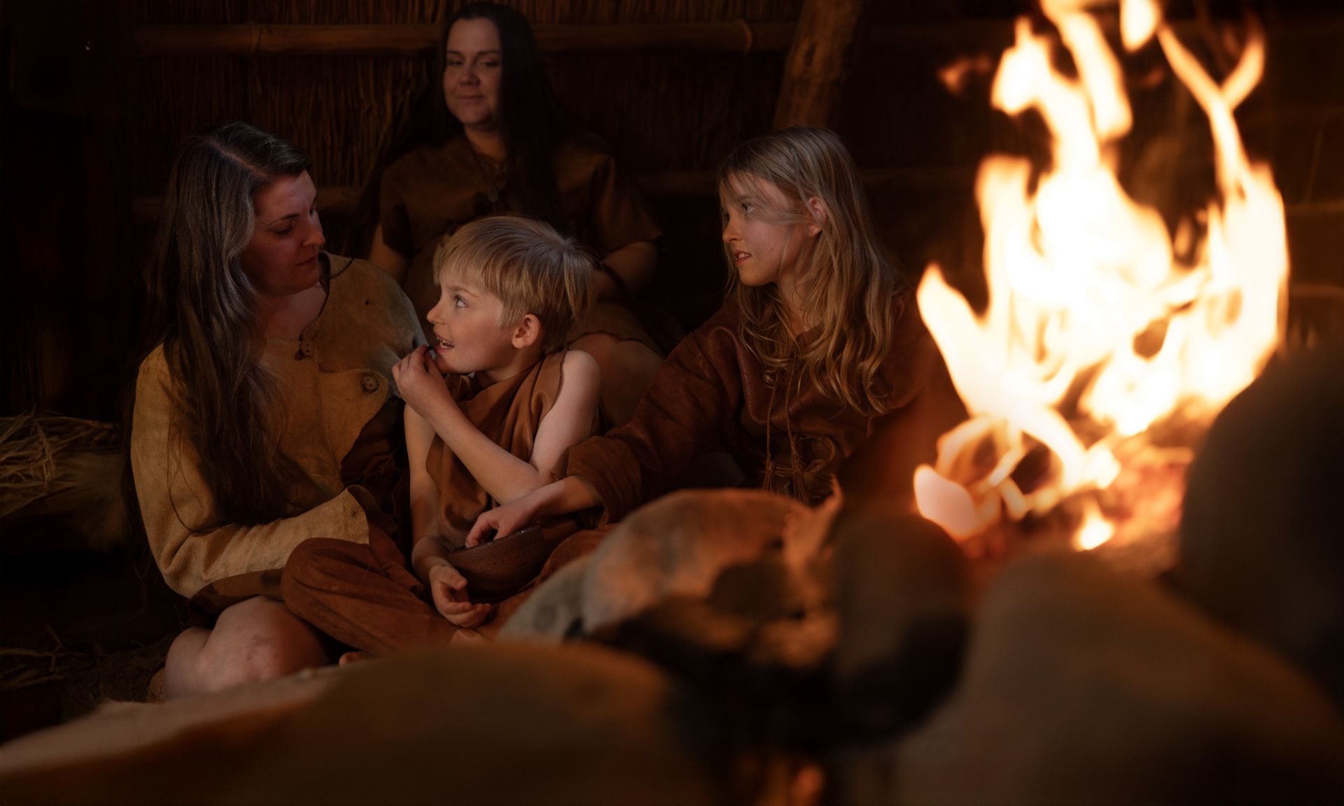 people in leather by the campfire
