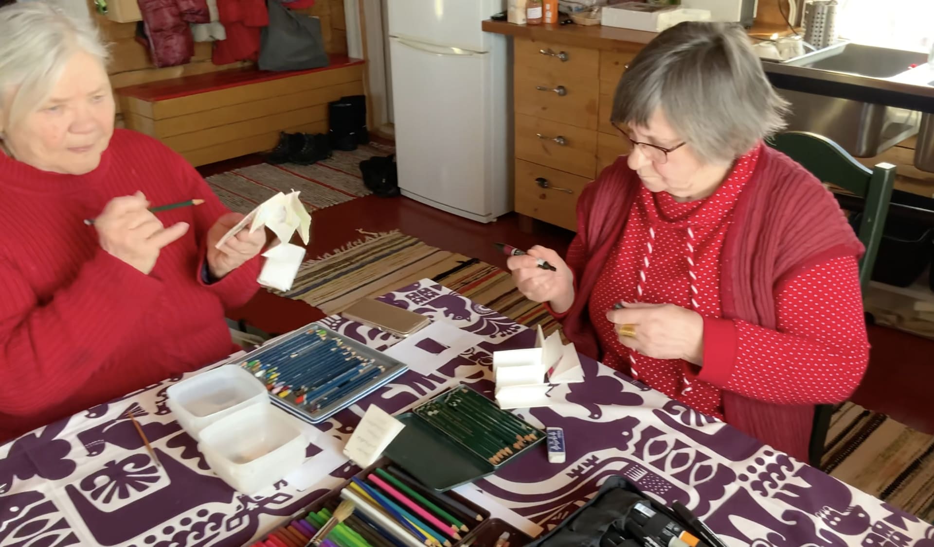 Seniors drawing Kalevala characters on the Kalevala Day in Finland