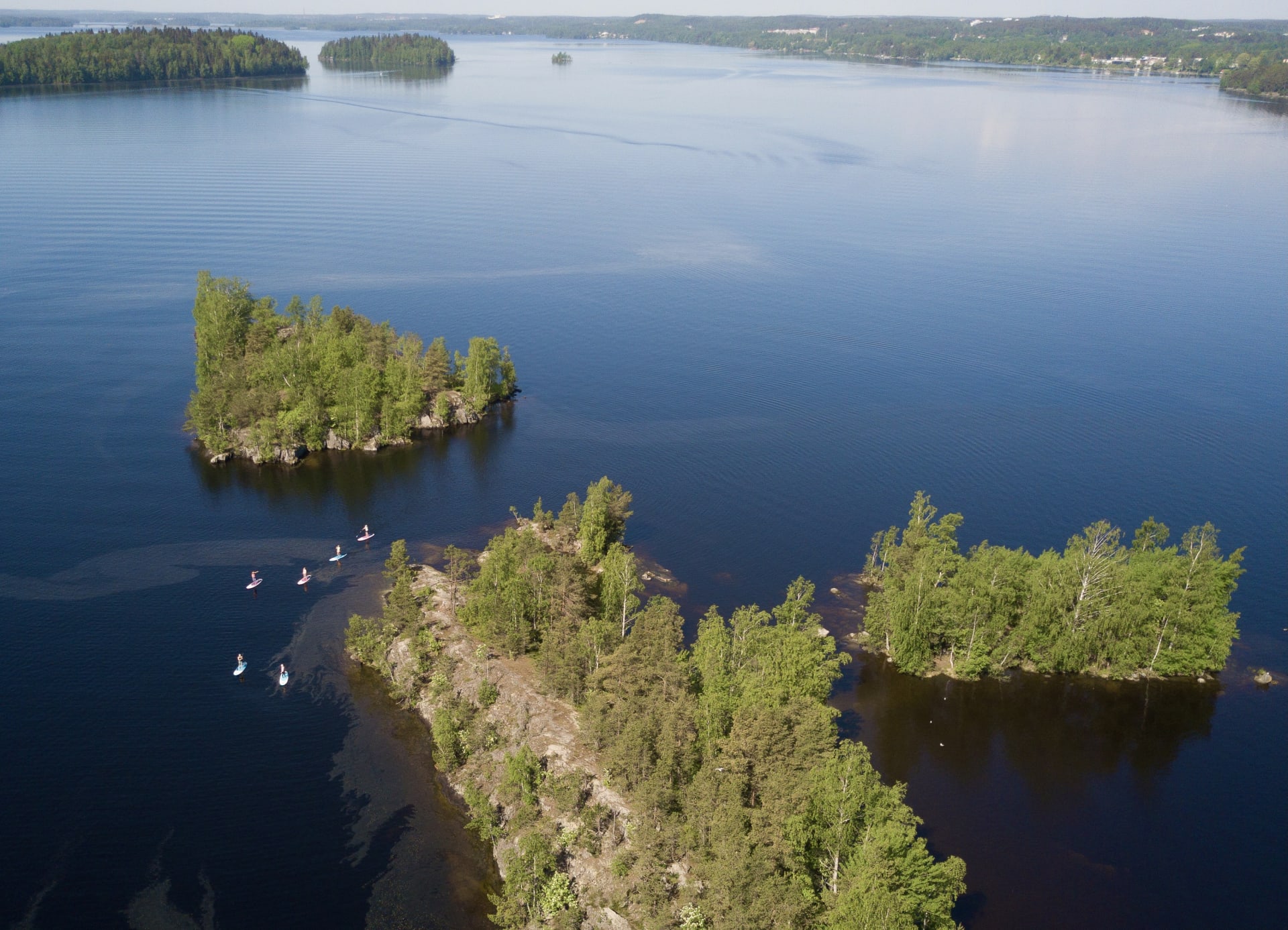 Group of people are stand up paddling between islands of Pyhäjärvi