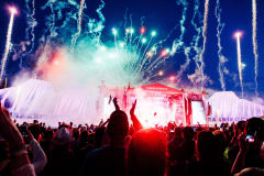 Ilosaarirock's Main Stage during Finnish band Haloo Helsinki!'s set at the festival in July 2024. Behind the stage, colourful fireworks.
