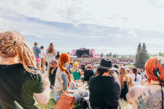The festival crowd pictured from behind by Ilosaarirock's YleX Stage in July 2024.