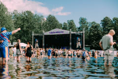 Ilosaarirock's Rento Stage in July 2024, pictured from the lake body of water by the stage.