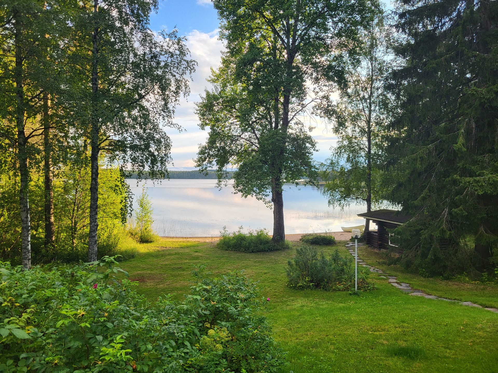 View from Hiisi Lodge terrace to the tranquil lake.
