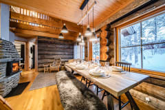 Log house dining room/living room. There's a reindeer hide on the dining table bench.