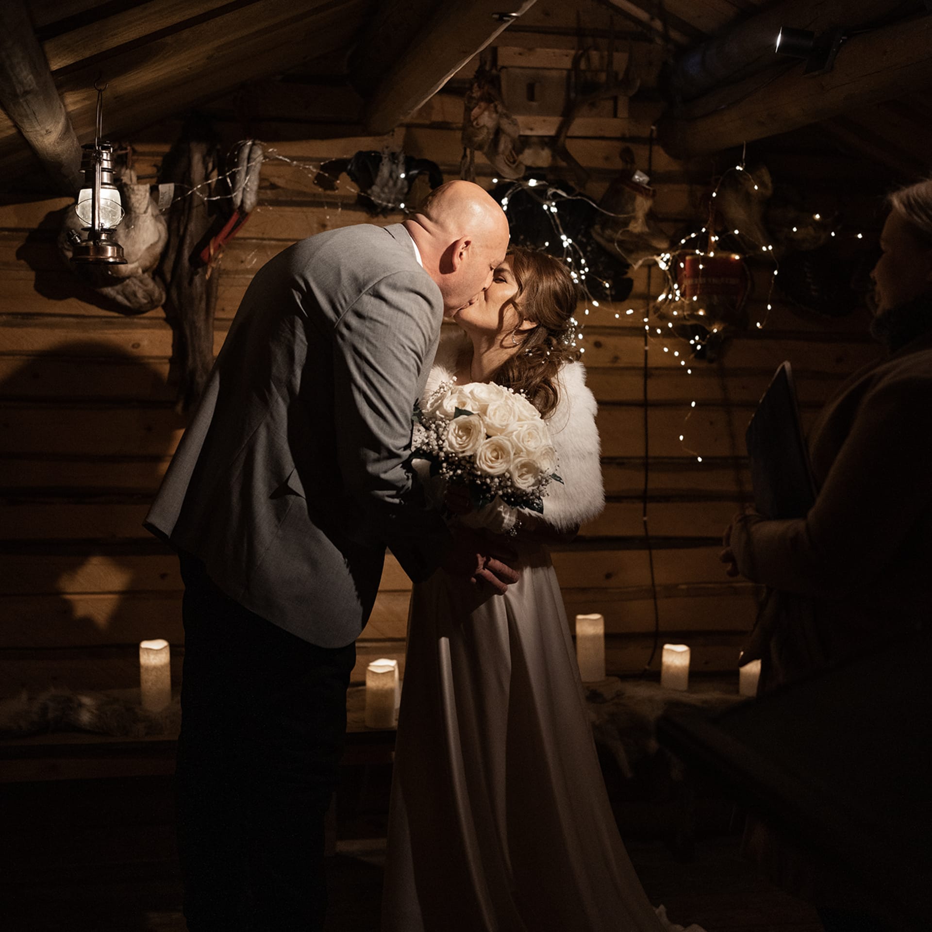 Indoor of the cottage is dark but filled with candles