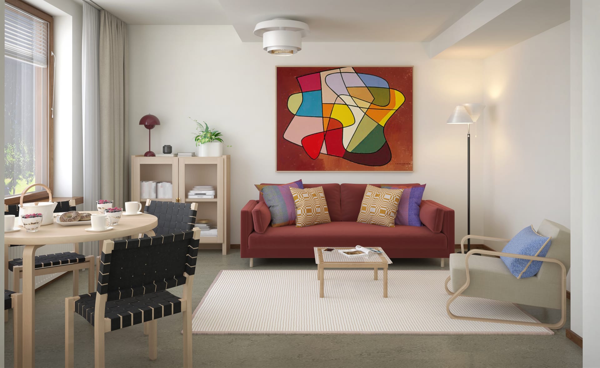 Tyylikäs olohuonealue jossa näyttävä taideteos ja punasävyinen sohva.