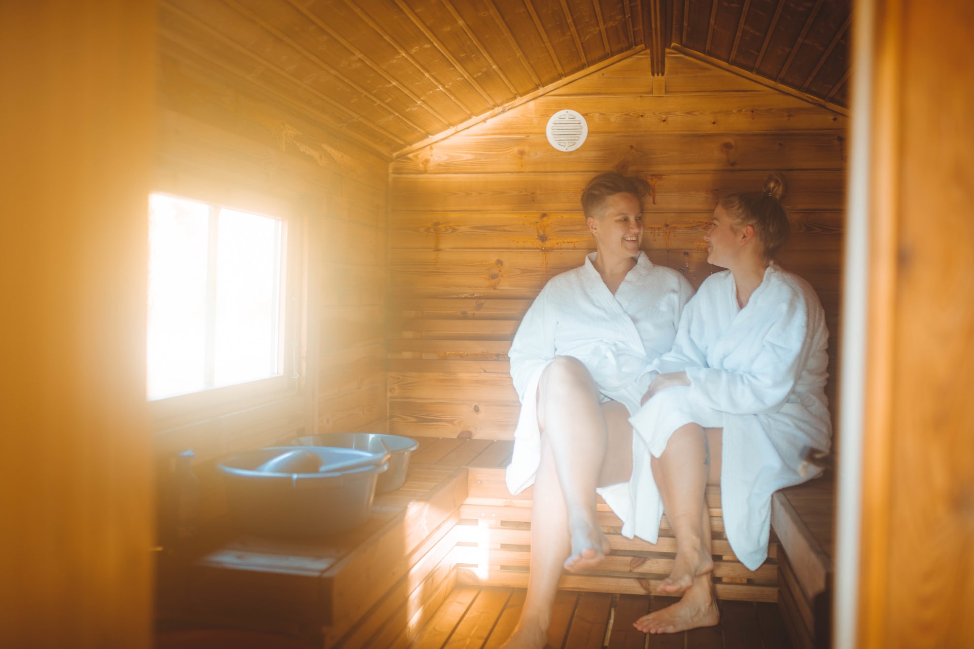 Two people in Apukka Resort Floating Sauna.