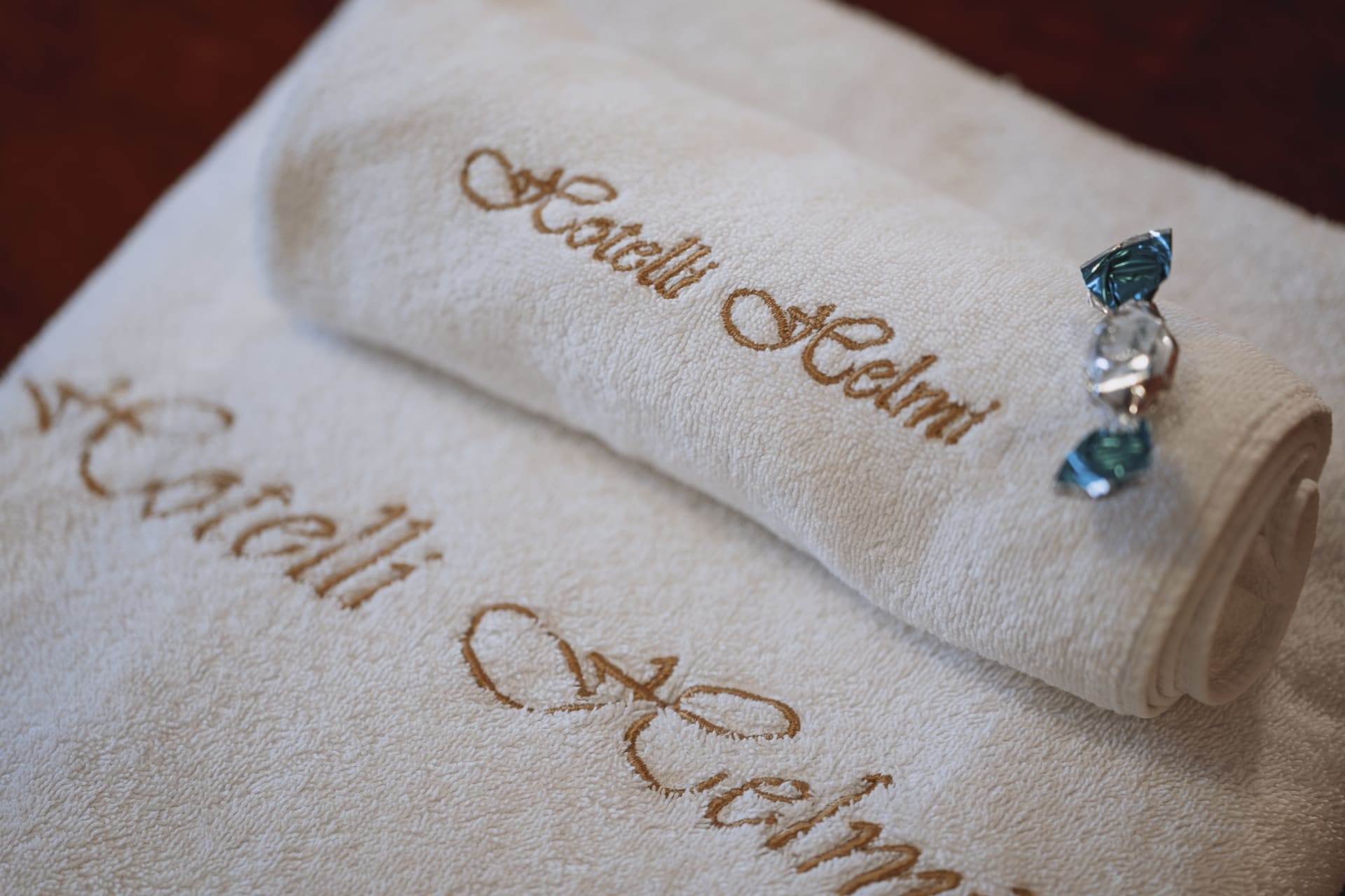 White towels, embroided with Hotelli Helmi.  White towels, embroided with Hotelli Helmi.