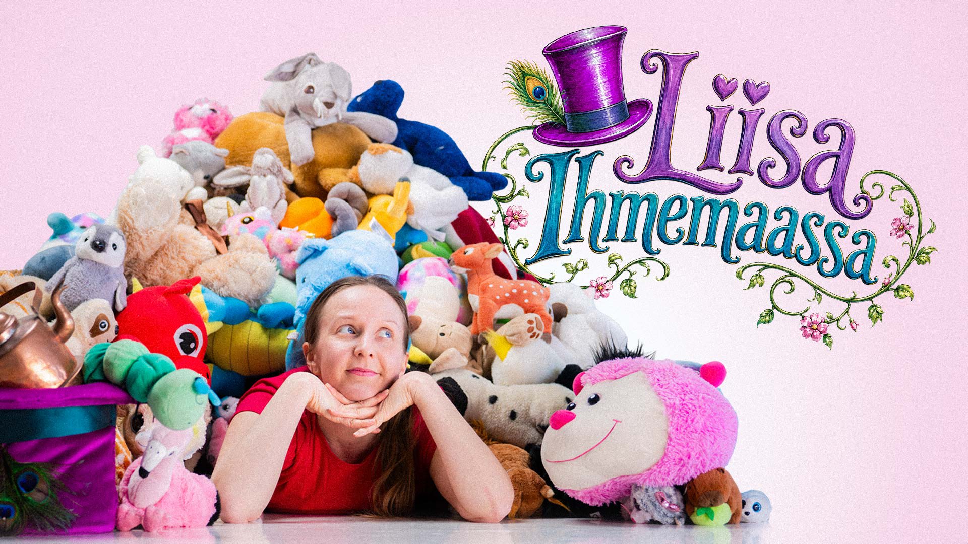 A woman lies among colorful stuffed animals. The image features the text “Liisa Ihmemaassa” and a purple top hat. The background is pink. A woman lies among colorful stuffed animals. The image features the text “Liisa Ihmemaassa” and a purple top hat. The background is pink.