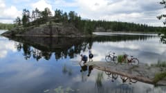 Two cyclist at the shore of Lake Saimaa