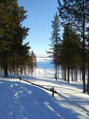 Open-air museum in winter with a view to Lake Inari
