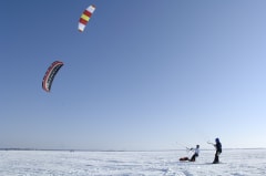 Kite surfers on the frozen sea.