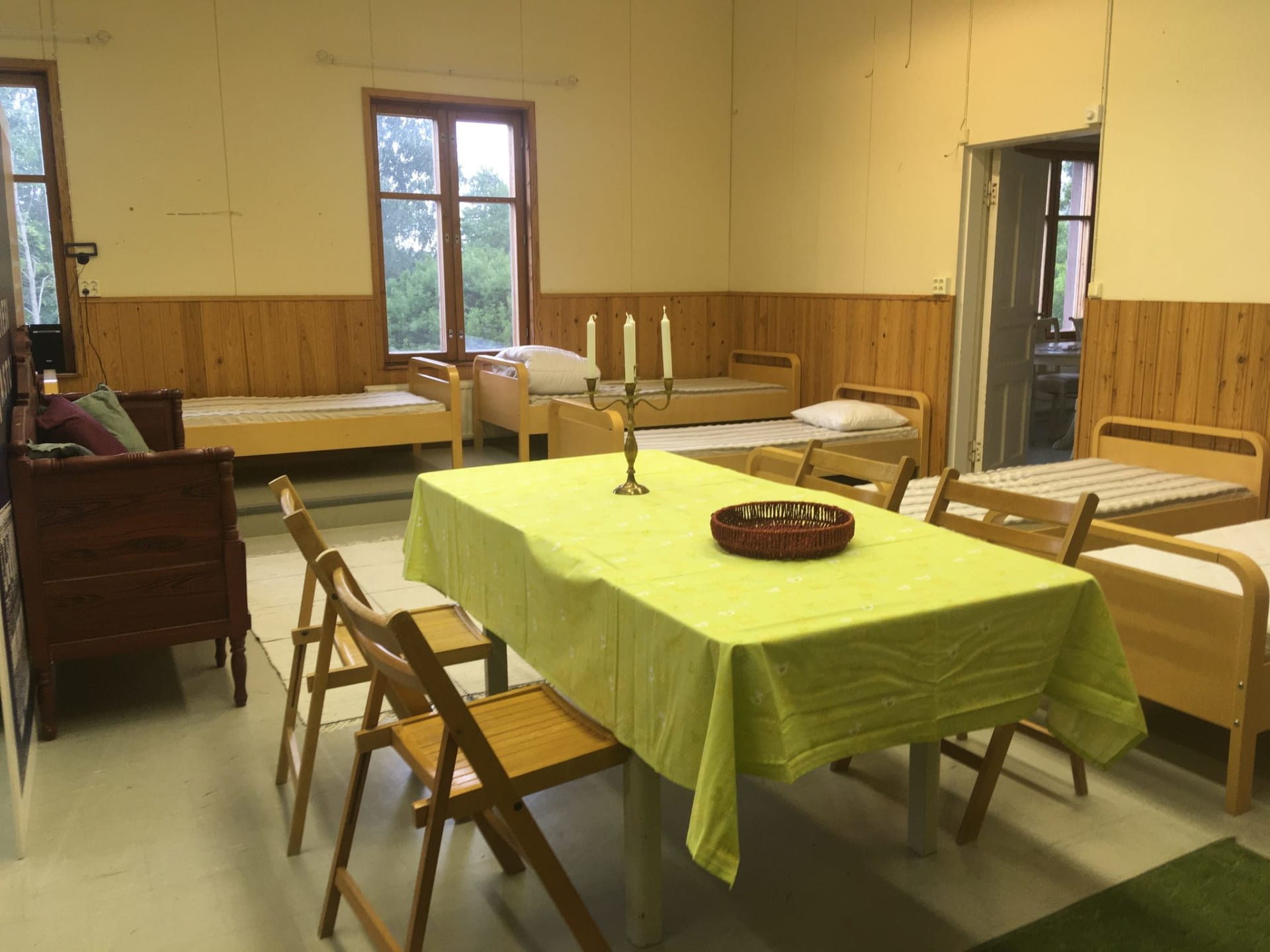 The meeting table is located in the middle of the dormitory.