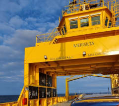 Yellow ferry called Merisilta, which operates between Oulu and Hailuoto. Background blue sky with white clouds.