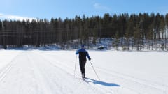 A man skiing on an ice ski track.