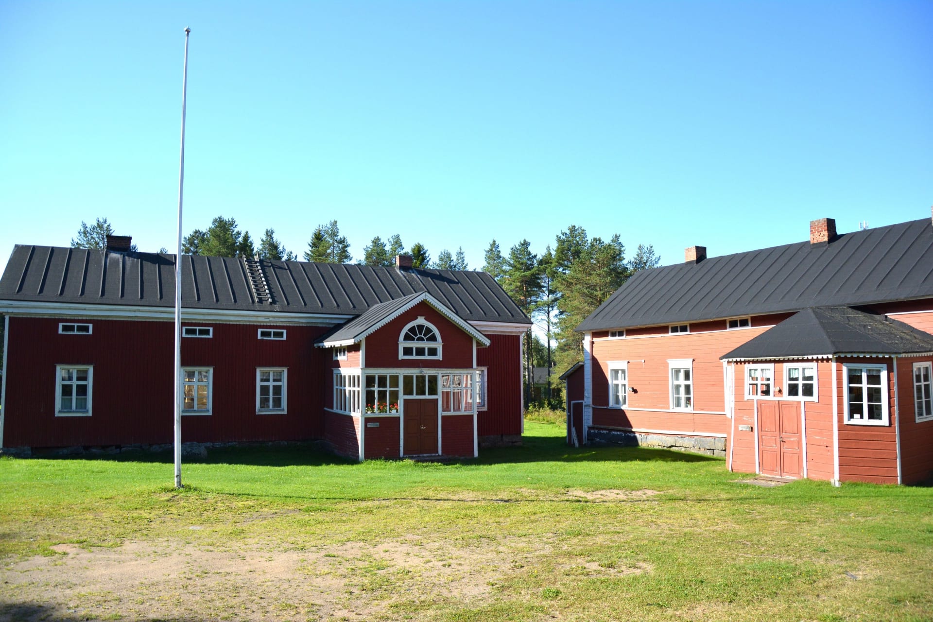 Court yard of the Annala Local History Museum with traditional red wooden houses