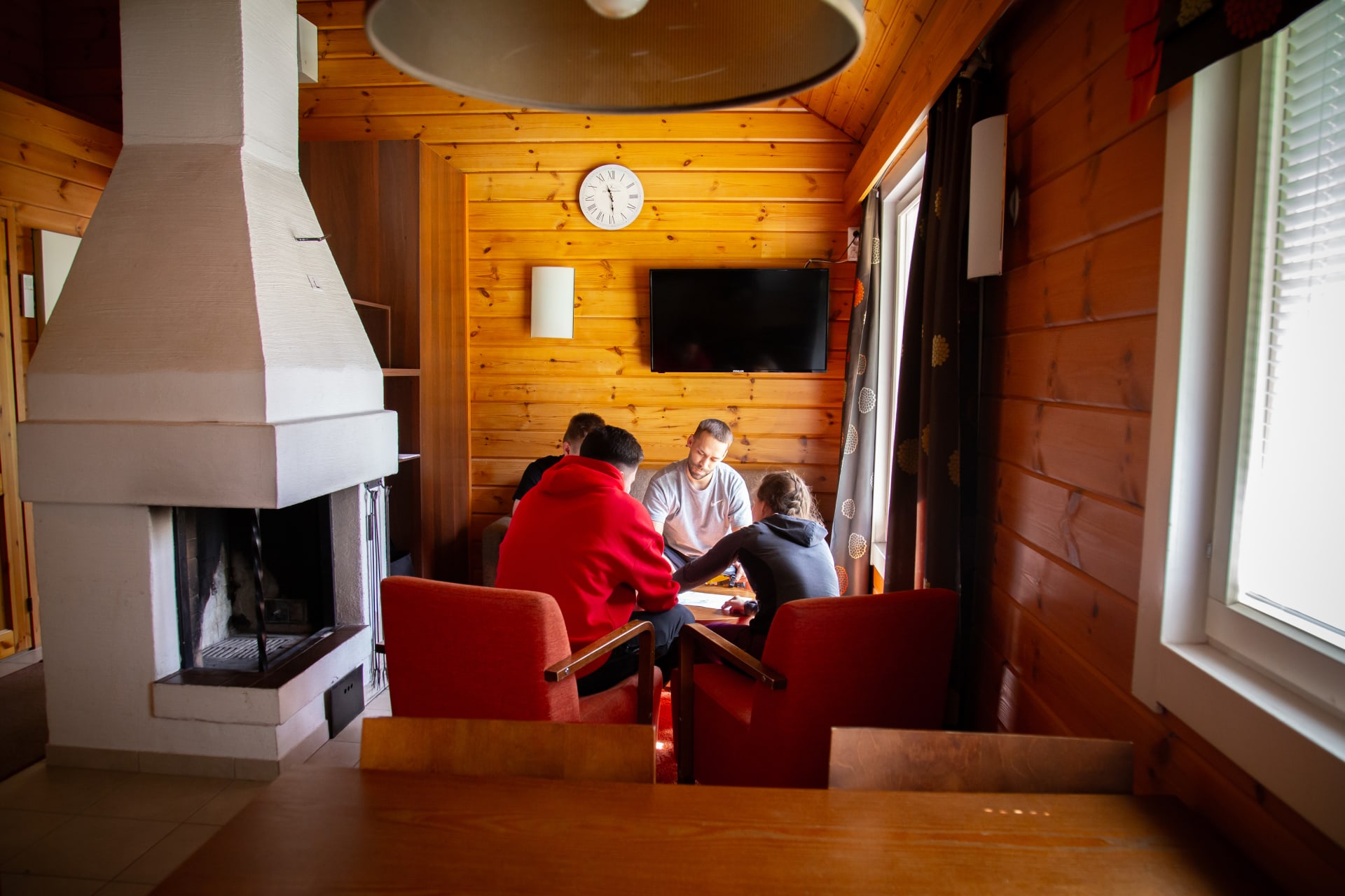 Four people sitting inside the Holiday Cottage