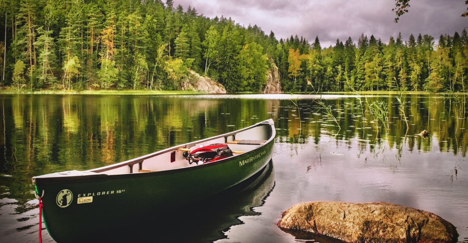The canoe rests in calm waters.