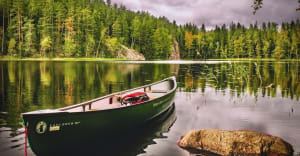 The canoe rests in calm waters.