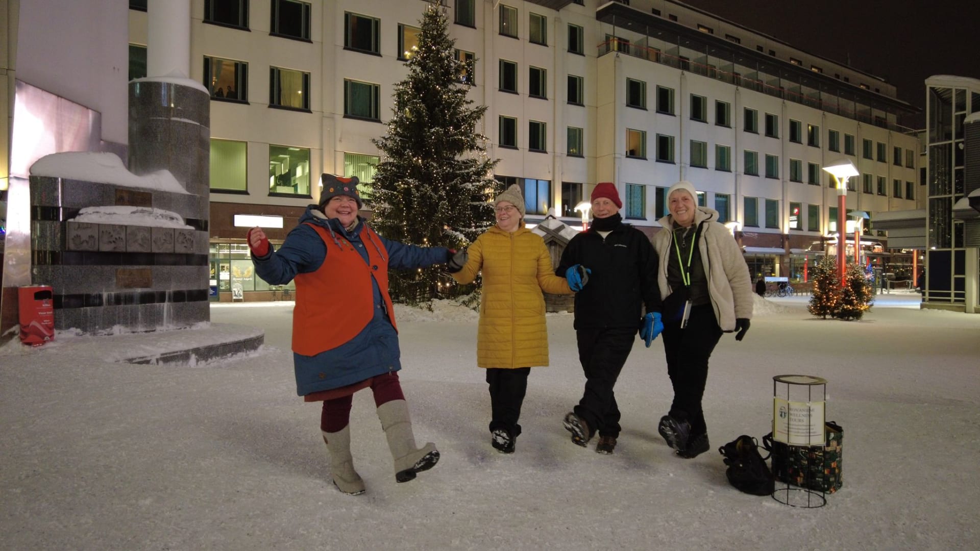 Good Will Elf dancing with two ladies and a gentleman at the Lordi Square.