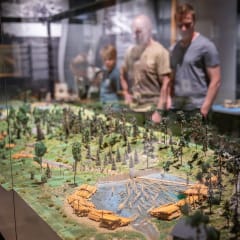 a miniature model where logs are floated along the river