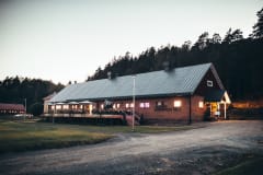The Manor Stables pictured during nightfall during the summer.