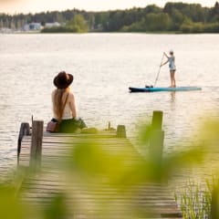 Summer picture with a girl on a dock