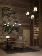 The reception area at Jänkä Resort featuring natural wood walls, a moss art installation, soft lighting, and a wooden desk, designed in a calm, Nordic style.