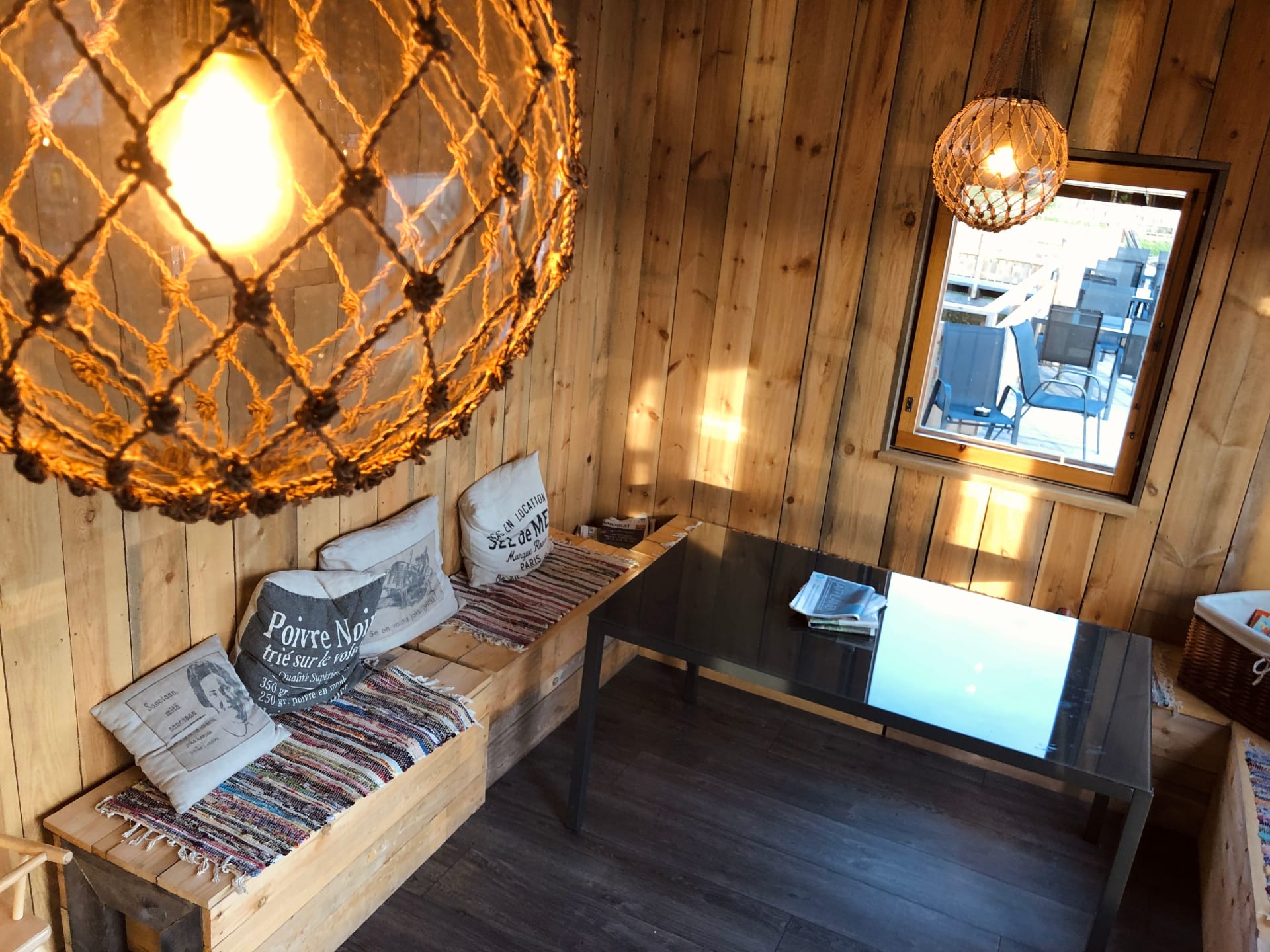 Inside a cozy corner of Cafe Laituri, rustic charm meets nautical-inspired décor, with warm light casting an inviting glow over the wood-paneled interior. Inside a cozy corner of Cafe Laituri, rustic charm meets nautical-inspired décor, with warm light casting an inviting glow over the wood-paneled interior.