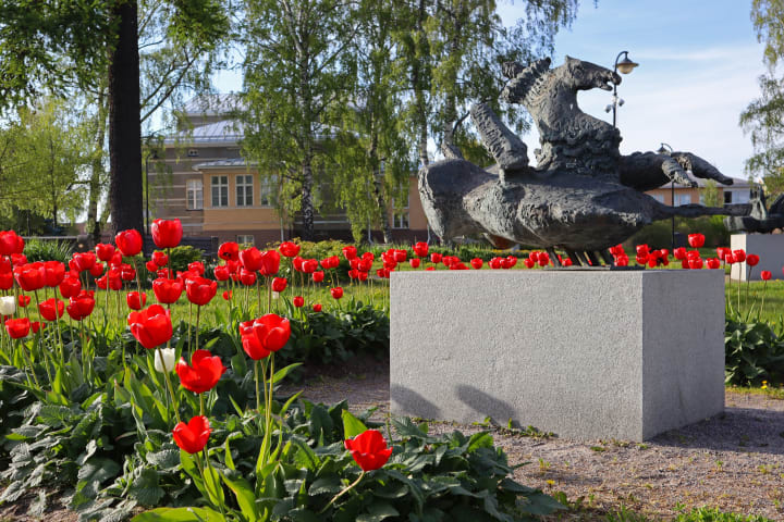 Red tulips surround one of Kari Juva's sculptures in Raahe. 