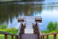 The dock and stairs leading up to it, pictured from the terrace of Villa Betlehem's lakeside sauna.