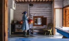 A person dressed in traditional costume in a museum.