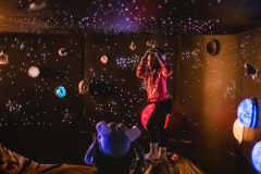 A child is playing in the Out-Of-This-World Space.