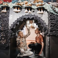 children admiring the crocheted mushroom forest