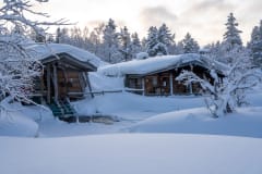 Kuurakaltio savusauna ja Kiilopuron avanto ulkopäin talvella.