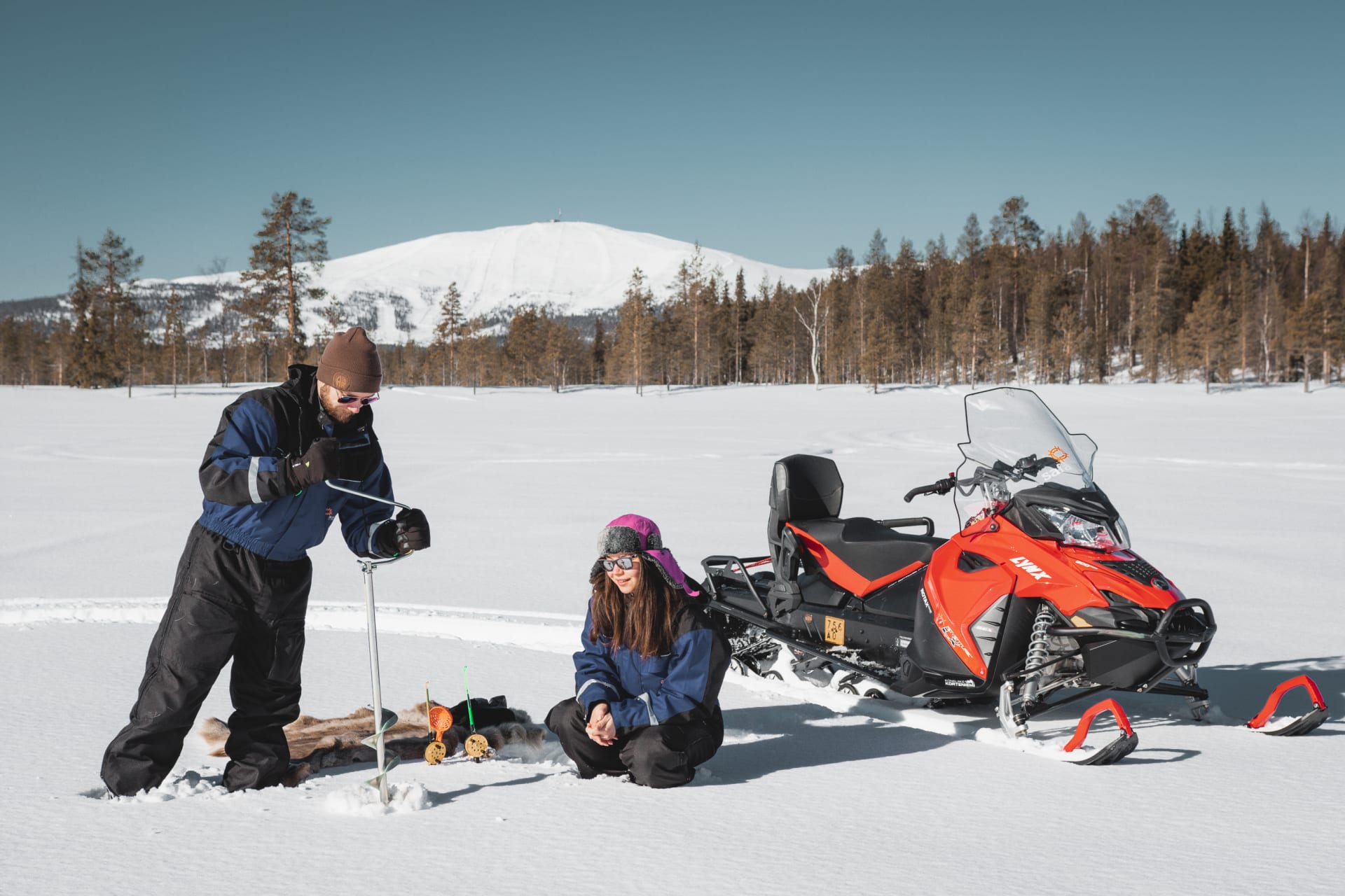 Ice fishing by snowmobiles