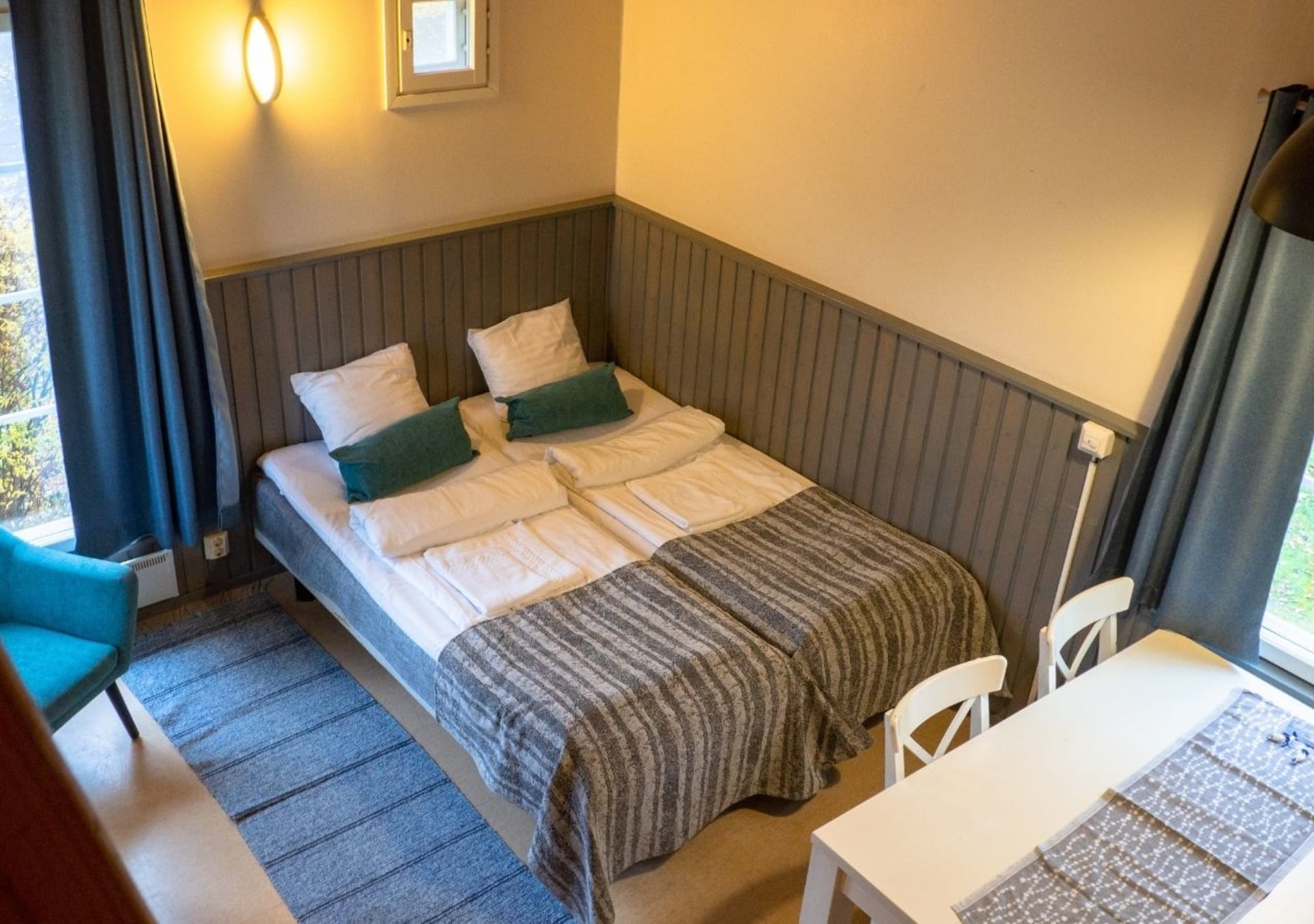 Studios have two beds in the combined living room and kitchen area.