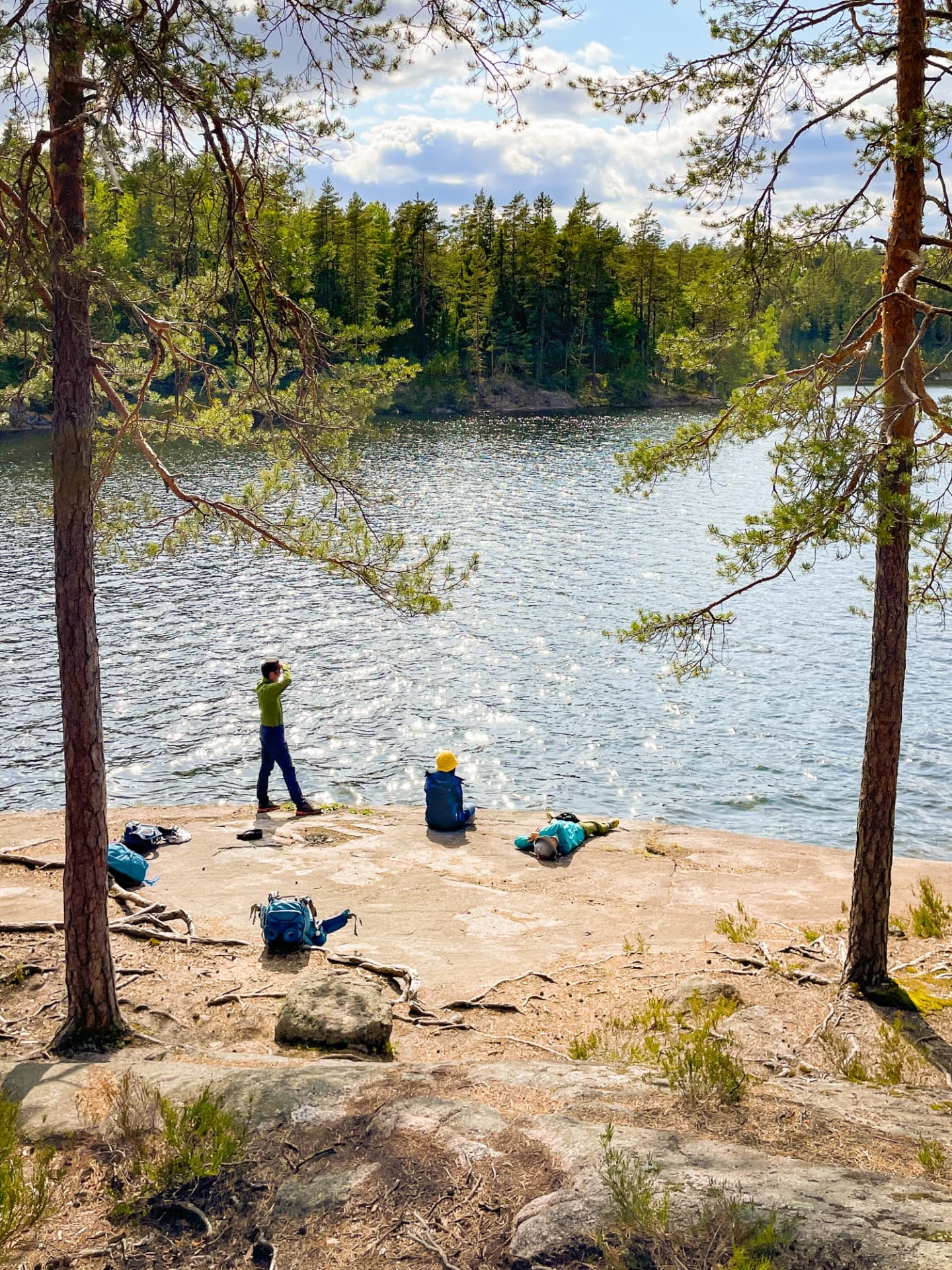 People relaxing by a lake in Nuuksio