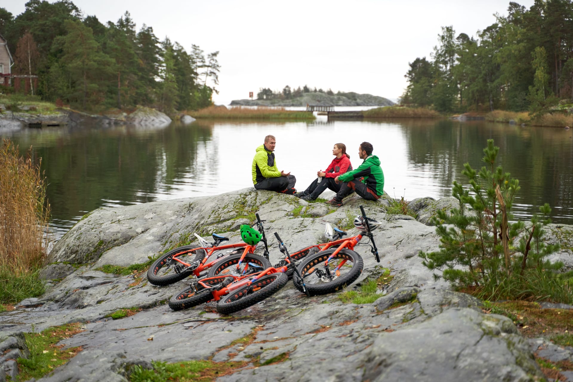 A group of fatbike riders taking a break by the sea