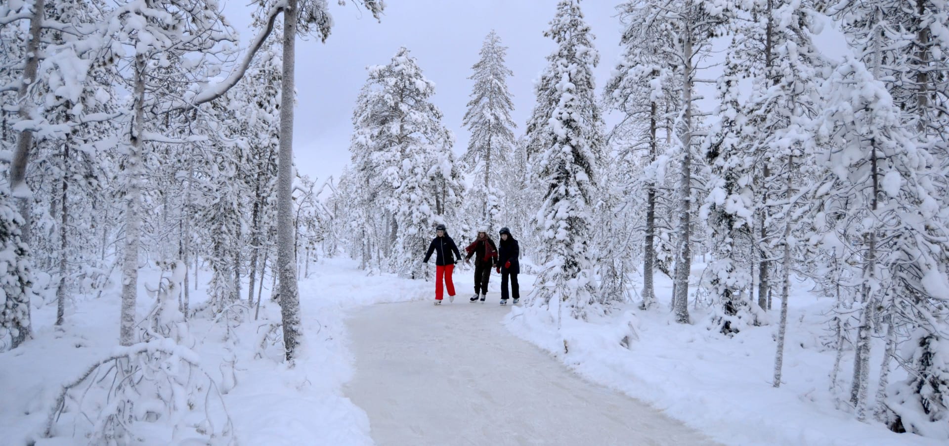 Ice skaters on ice skating track in Lappish forest