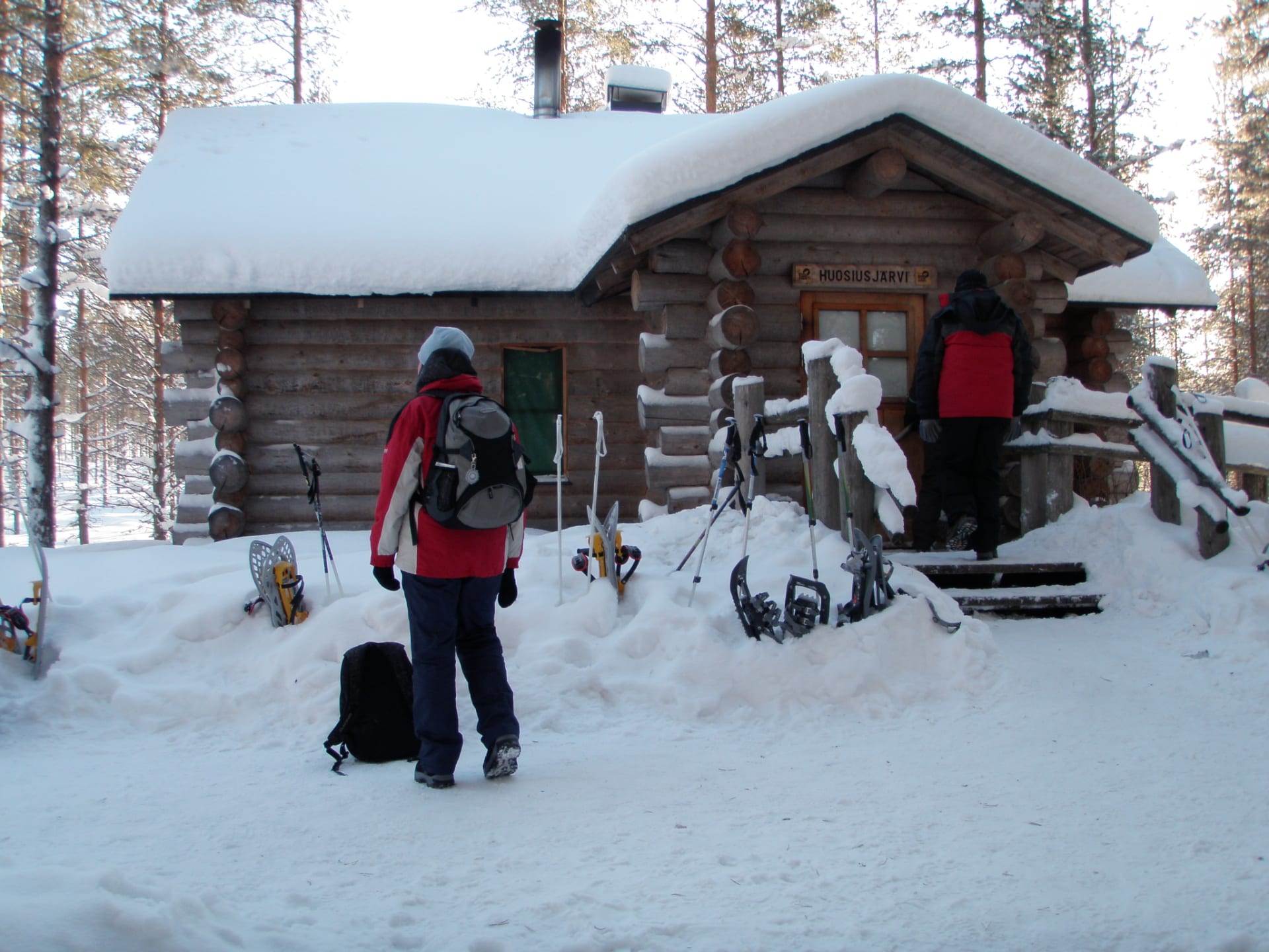 Two men entering at a wilderness hut