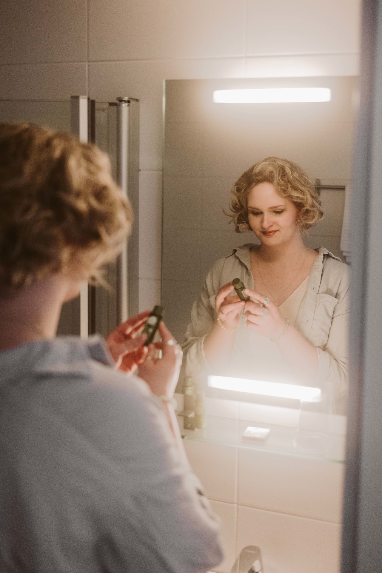 Guest doing her make up at the hotel rooms bathroom.