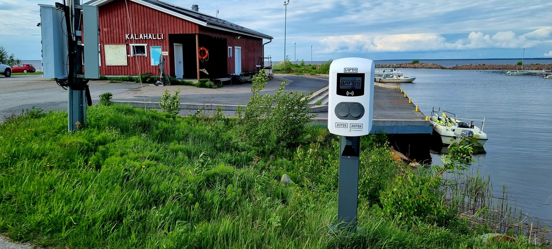 E-charging station, in the background there's the fishing hall