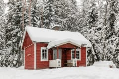 Wilderness cabin Tikankolo is covered by snow in winter