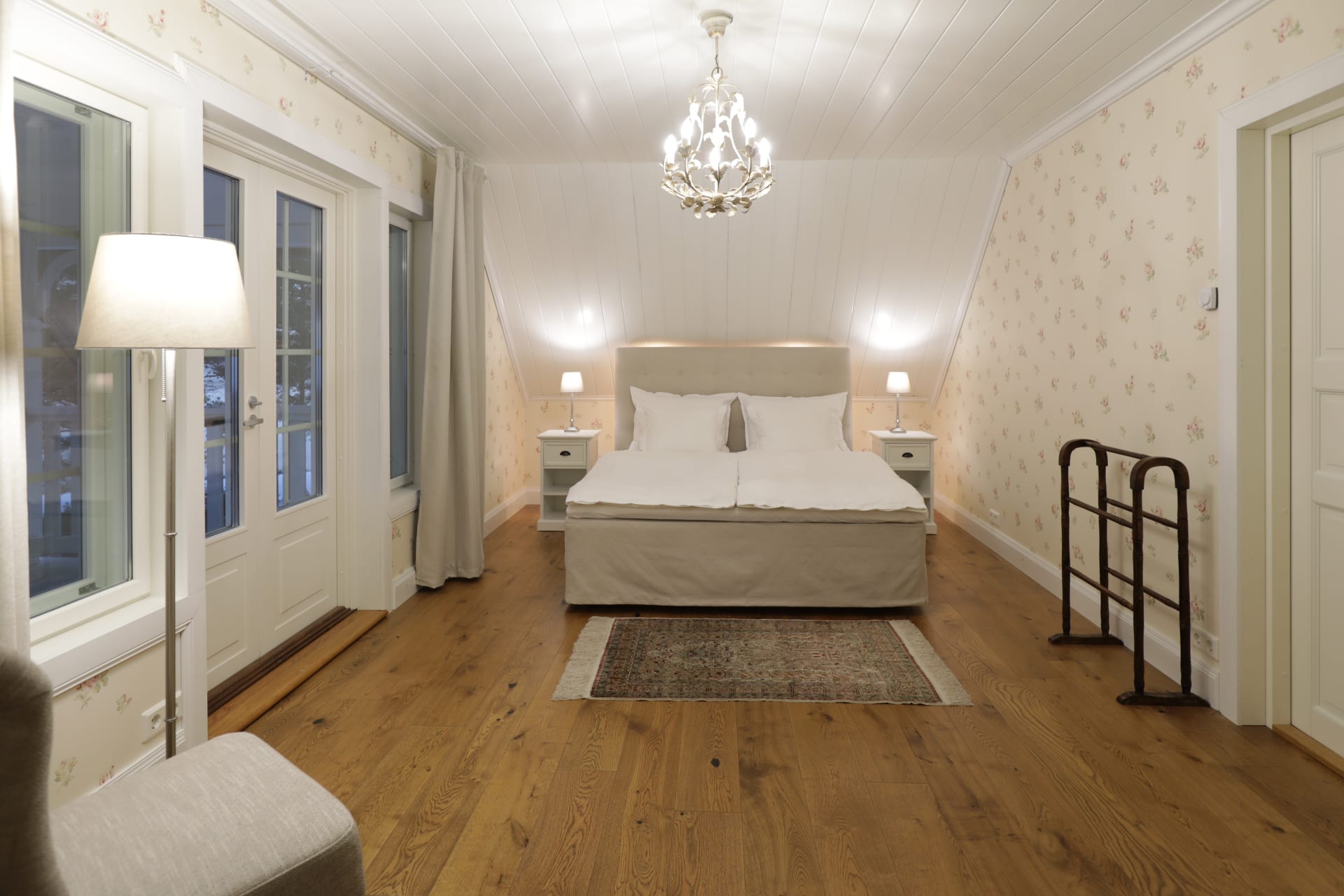 Villa Cone Beach master bedroom features a DUX double bed with headboard, additional furniture, and double doors to the balcony, perfect for morning coffee.